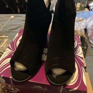 Black short booties with peep toe and zipper in the back. Brand new